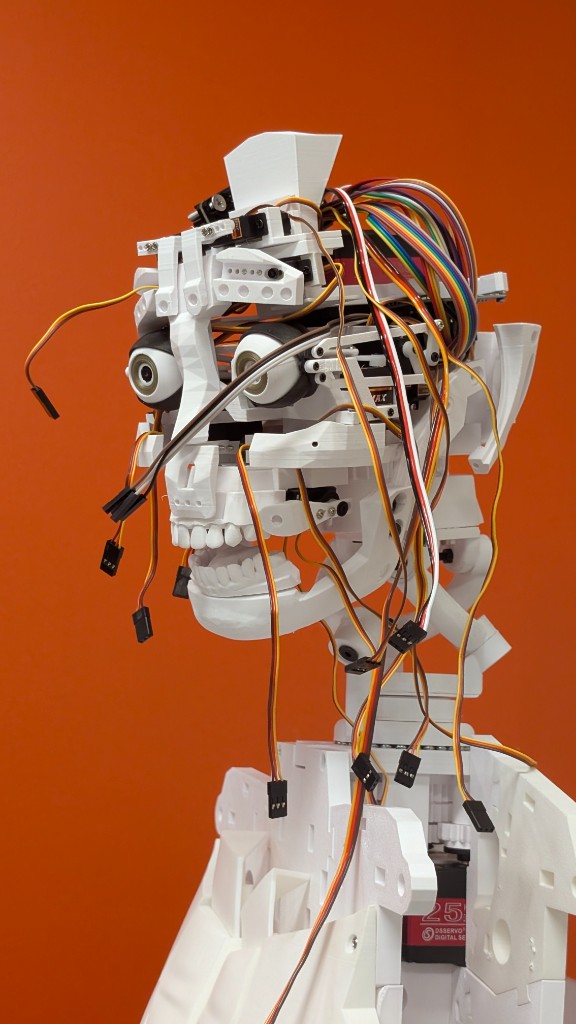 Cutaway view of the humanoid robot head showing internal mechanics and sensing.