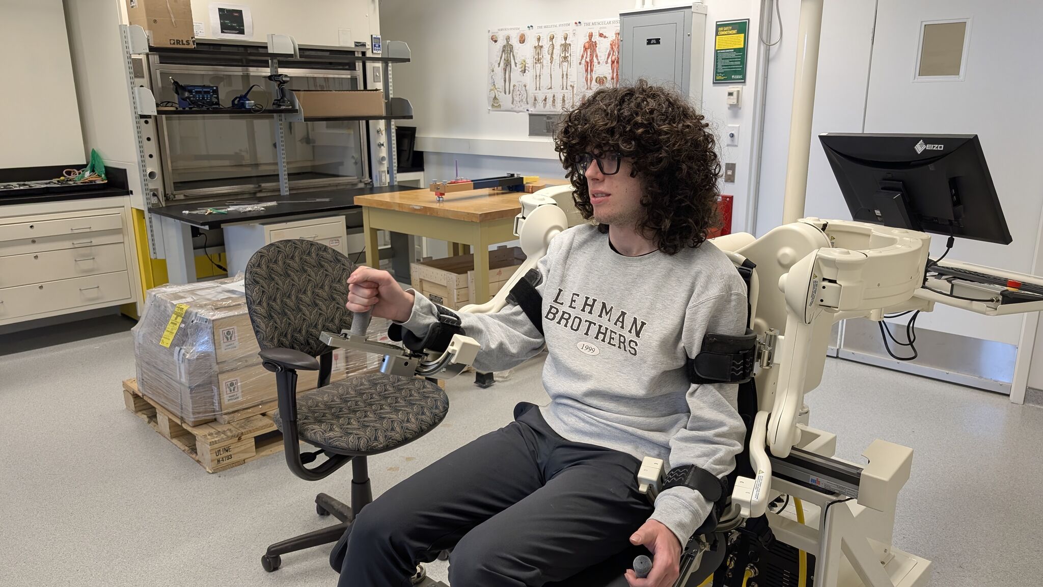 Rio testing the stroke rehabilitation robot arm in the lab.